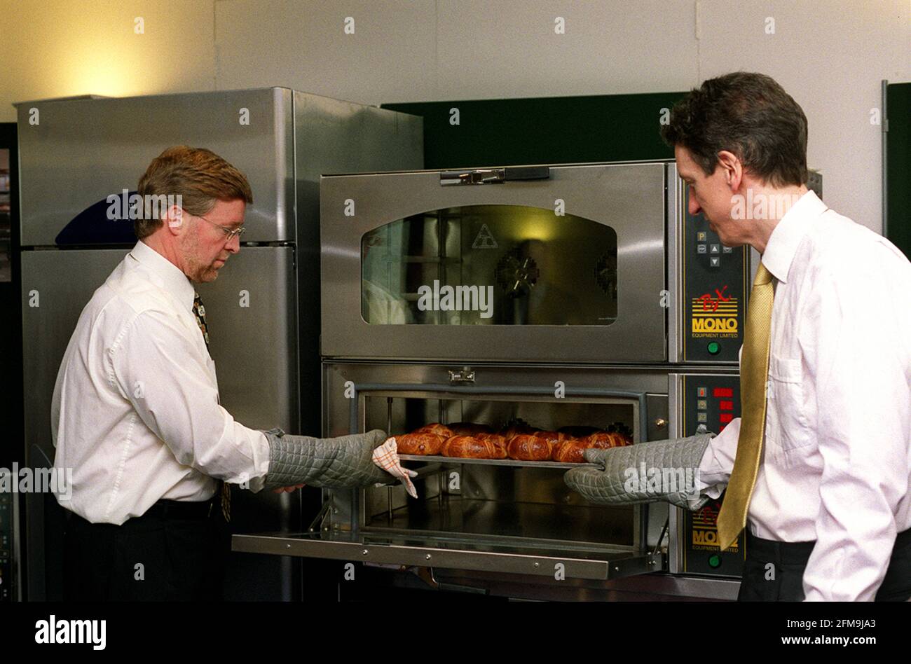 AGA Foodservices Group PLC Photocall March 2001 LEFT Stephen Rennie Chief Operating Officer and  RIGHT William McGrath Chief Executive use one of their ovens Stock Photo