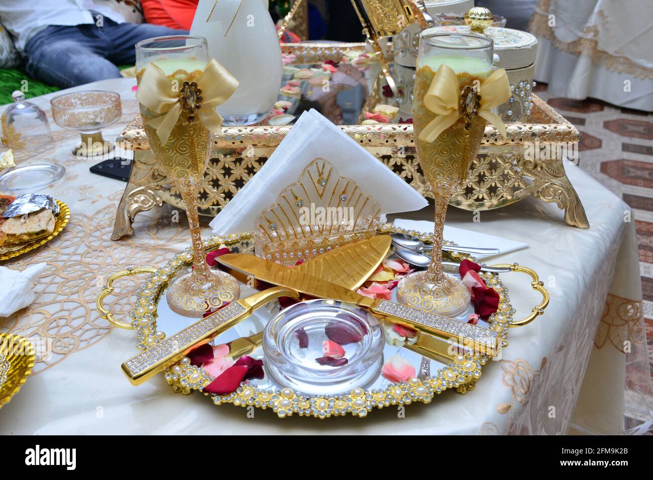 Moroccan wedding table. Milk cups to be served to the bride and groom. Arab wedding traditions Stock Photo