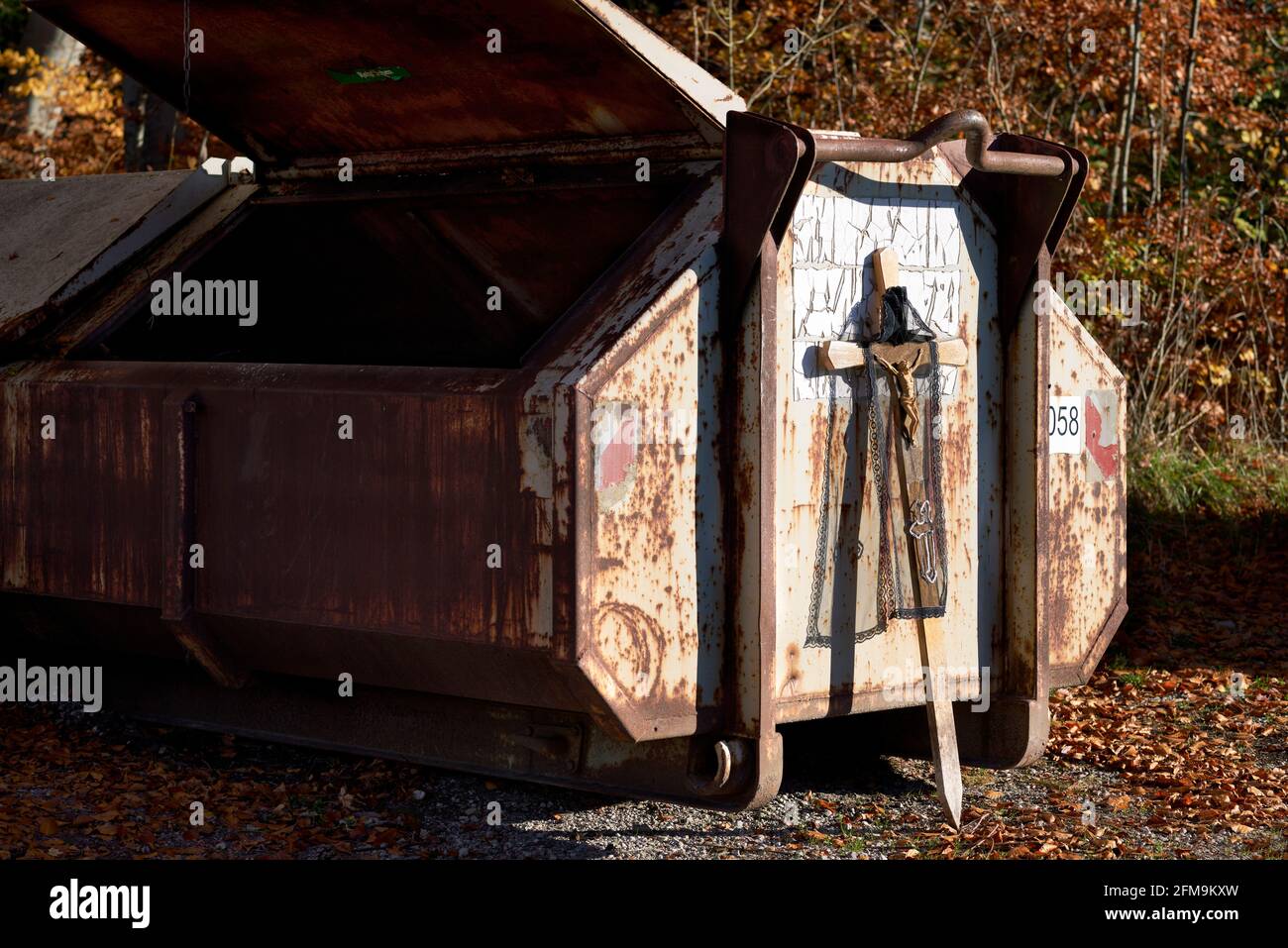 Catholic wooden cross, parked on a dumpster Stock Photo