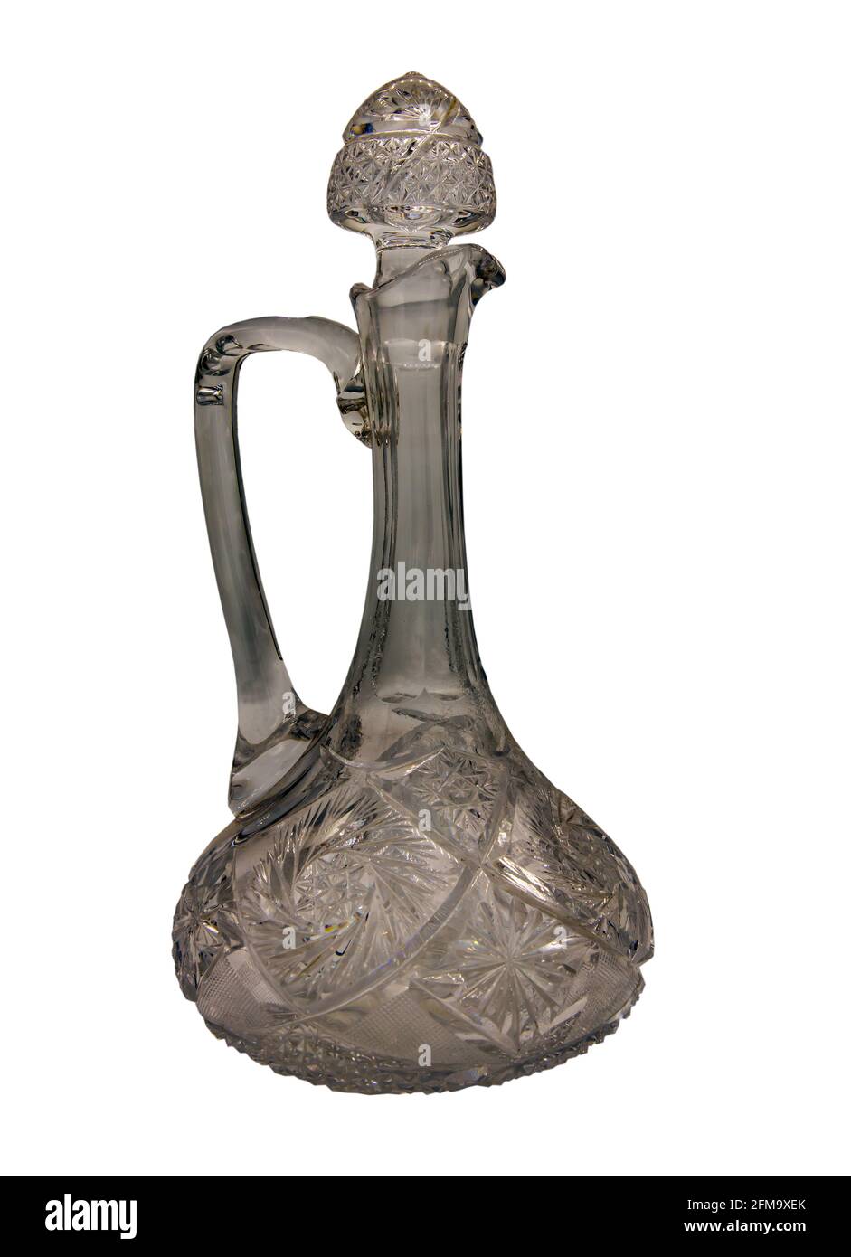 Empty antique crystal pitcher with glass handle and Closed with a glass stopper isolated on white background with clipping path. An traditional wine g Stock Photo