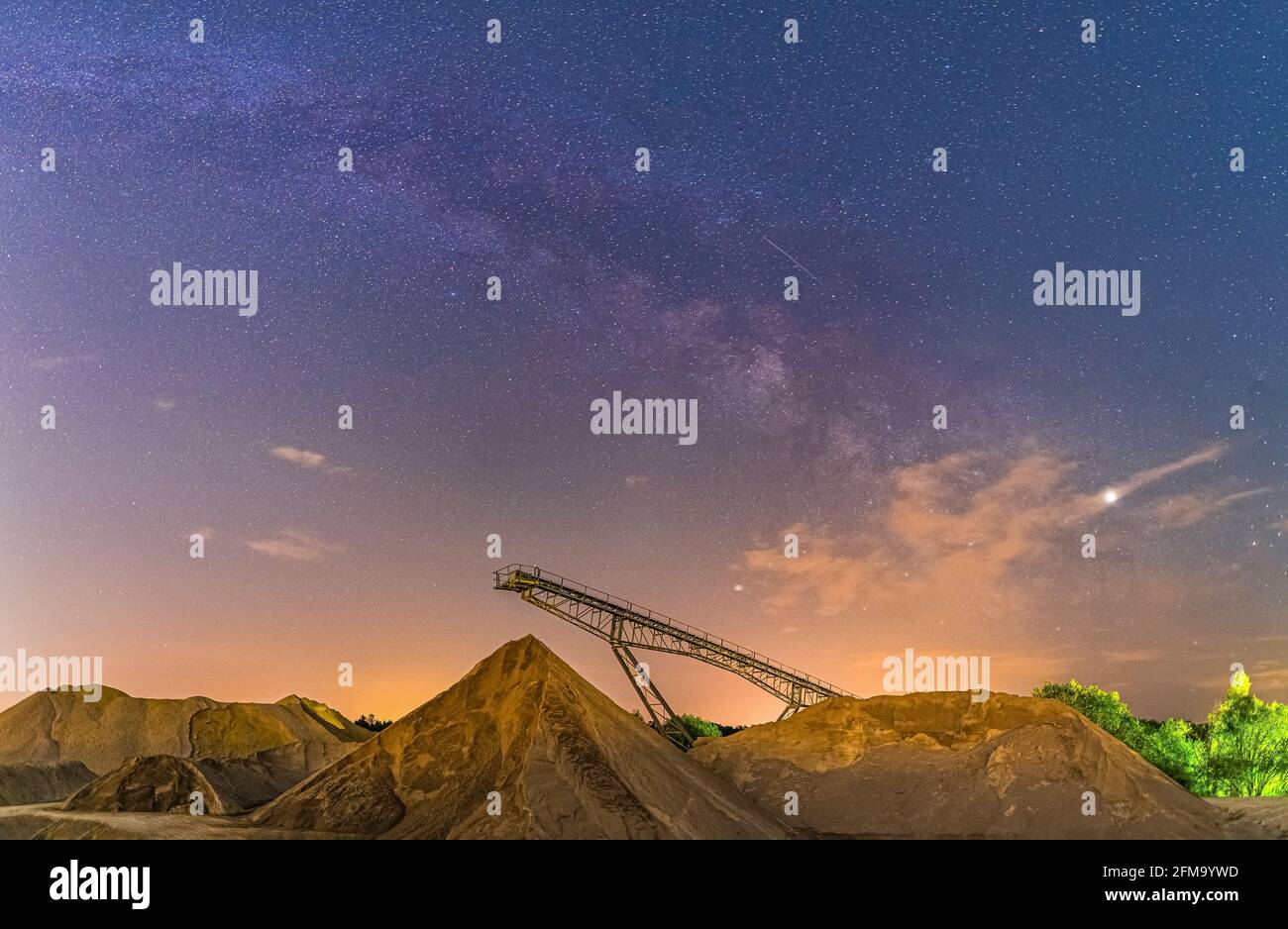 Conveyor bridge at night and the milky way, watching the stars at a construction area. Stock Photo