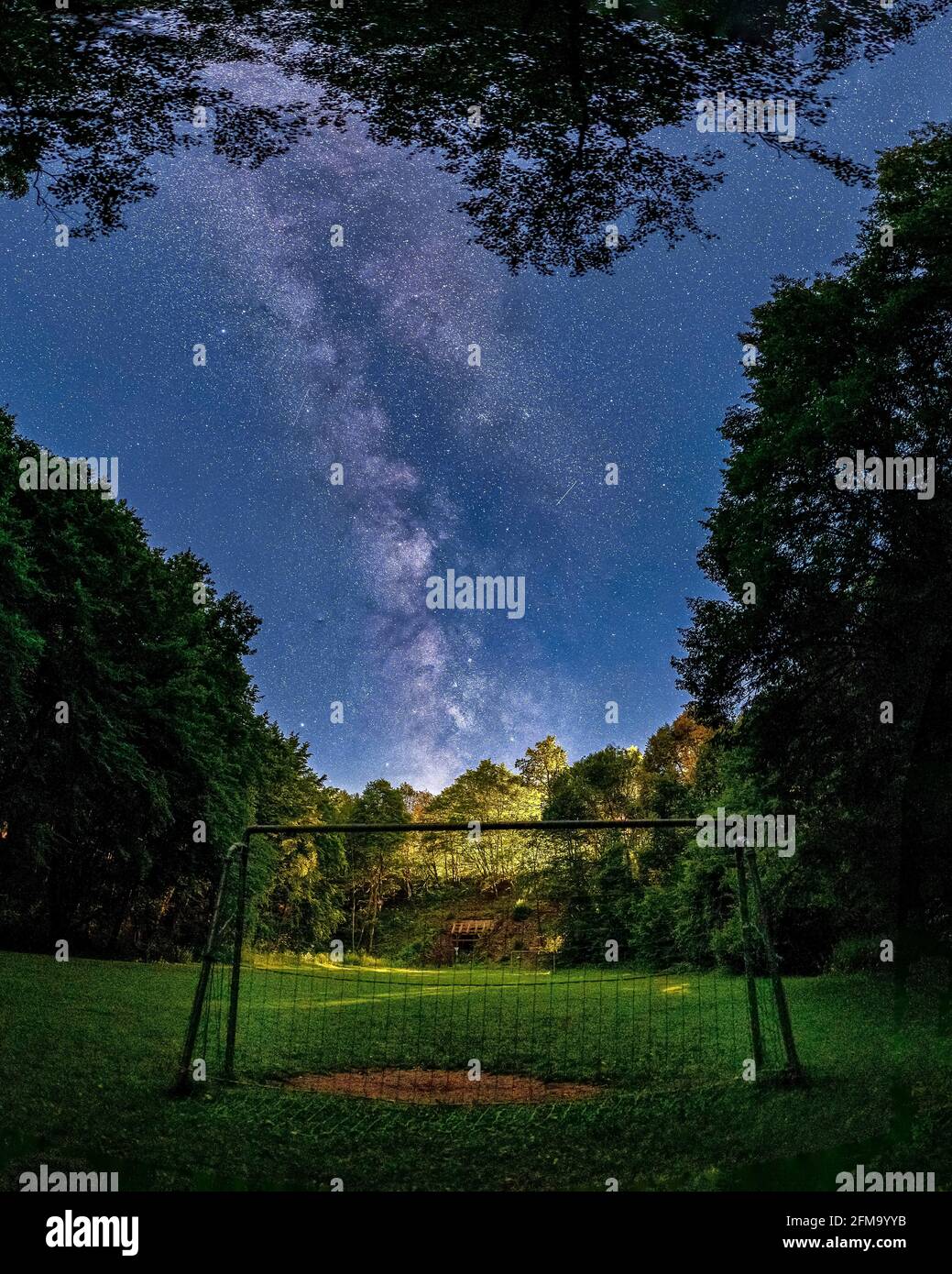 Soccer goal on the field with milky way in the background. Stock Photo