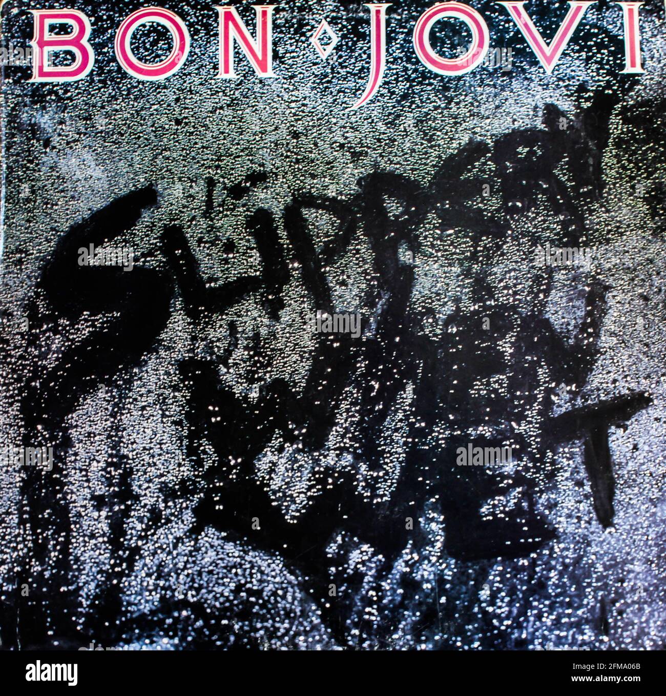 Glam metal and hard rock artist, Bon Jovi music album on vinyl record LP disc. Titled: Slippery When Wet album cover Stock Photo