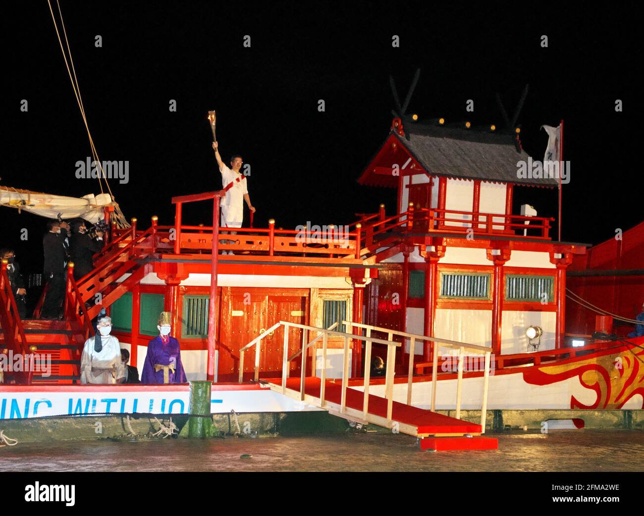 Nagasaki, Japan. 07th May, 2021. A torchbearer poses for camera on the