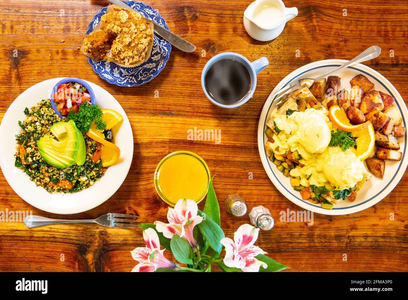 vegetarian eggs Benedict and a vegan scramble are enjoyed by two freiends Stock Photo