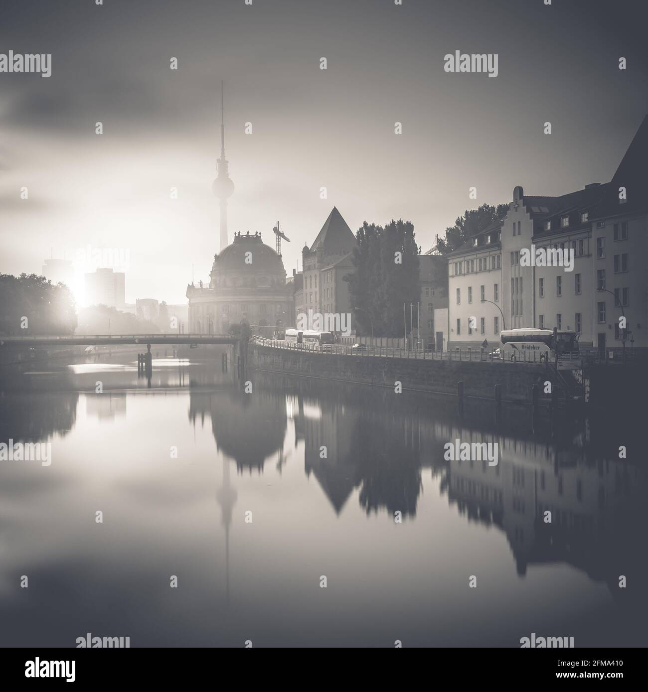 Reflection of the Berlin TV tower and the Bode Museum on Museum Island on the Spree at sunrise. Stock Photo