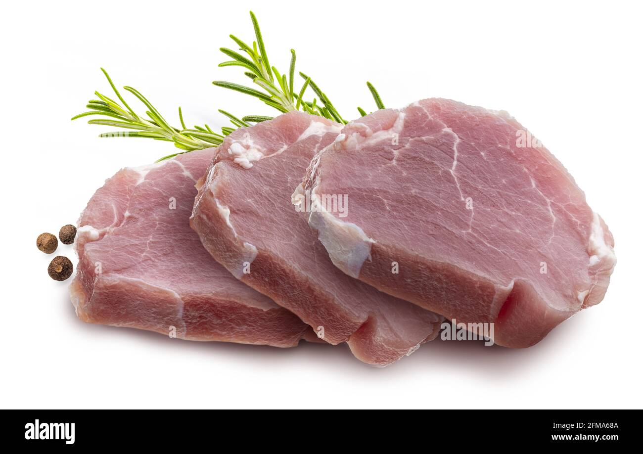 Raw pork tenderloin (sirloin) steaks (chunks), juicy and fresh. Isolated on white background. With rosemary leaves and black pepper. Isolated on white Stock Photo