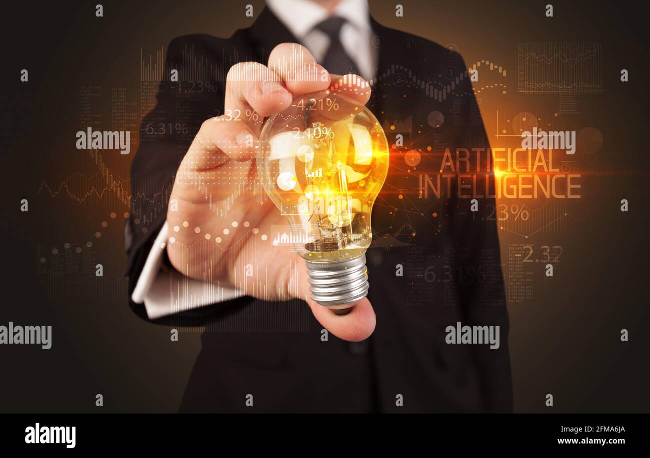 Businessman holding a lightbulb concept Stock Photo - Alamy