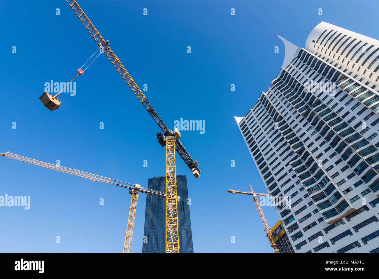Vienna, cranes at construction site, blue sky, DC Tower 1, highrise