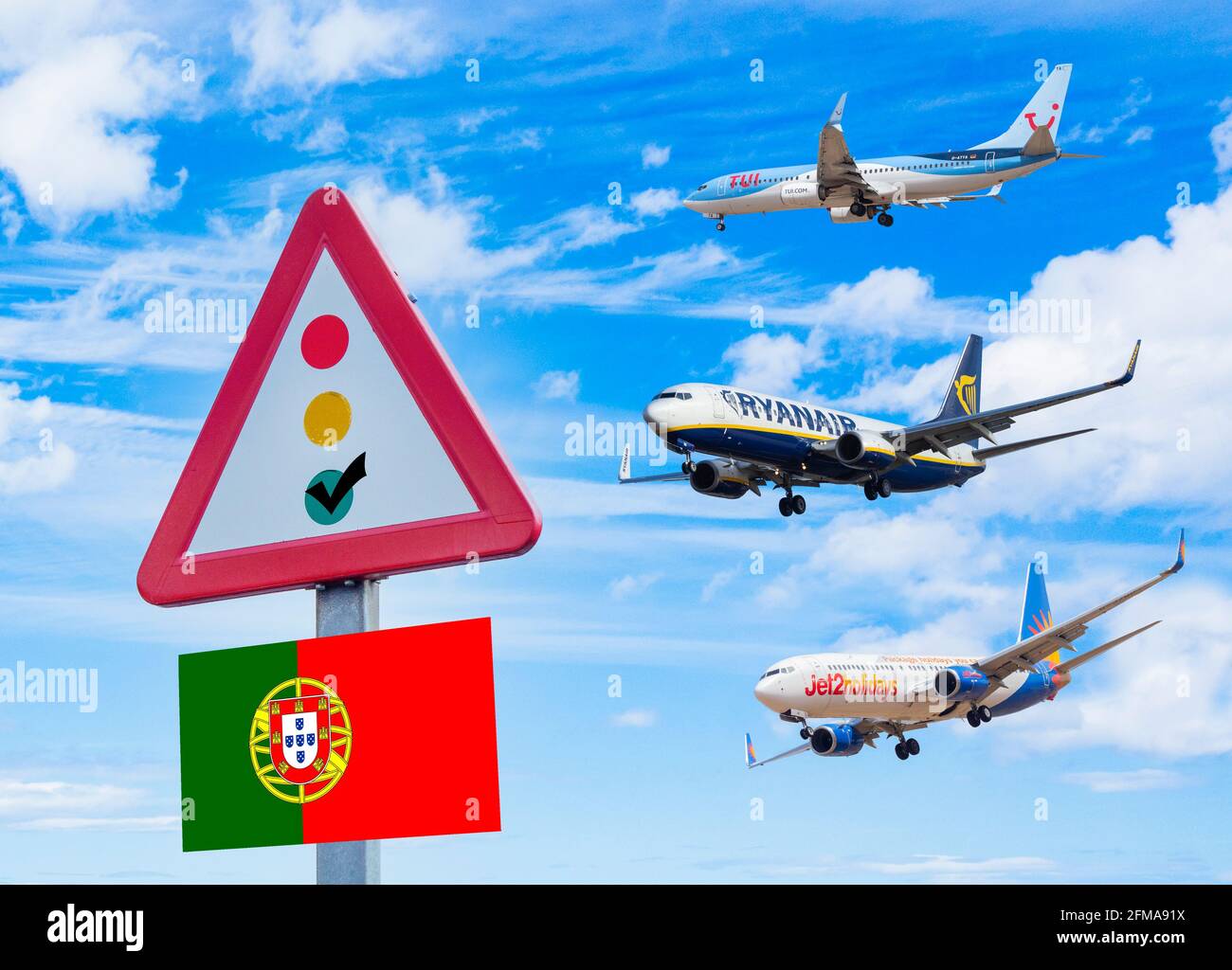 Green traffic light sign with flag of Portugal overlayed with TUI, Ryanair and Jet2 airplanes in background. Covid, Coronavirus travel concept Stock Photo