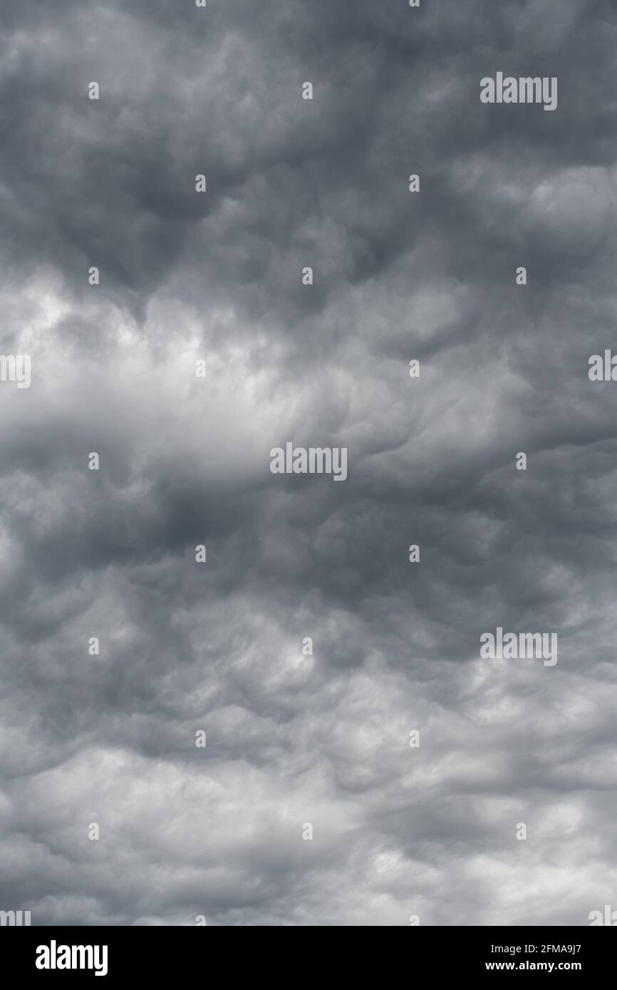 Moody sky with clouds forming  shapes.  A gray overcast day is enlightened by soft shapes in the cloud deck Stock Photo