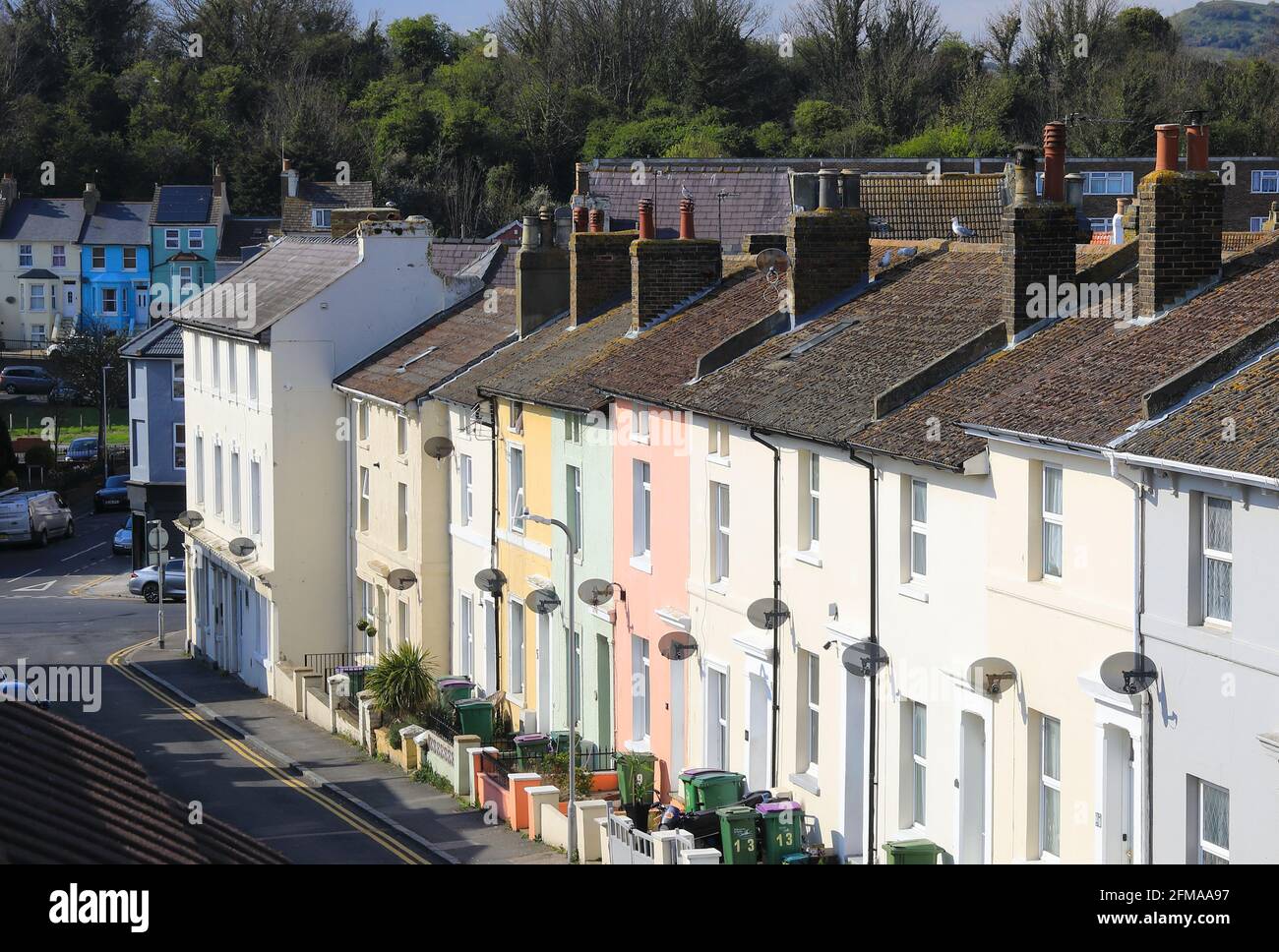 Pastel coloured terraced houses on Harvey Street in the harbour area of Folkestone, in Kent, UK Stock Photo