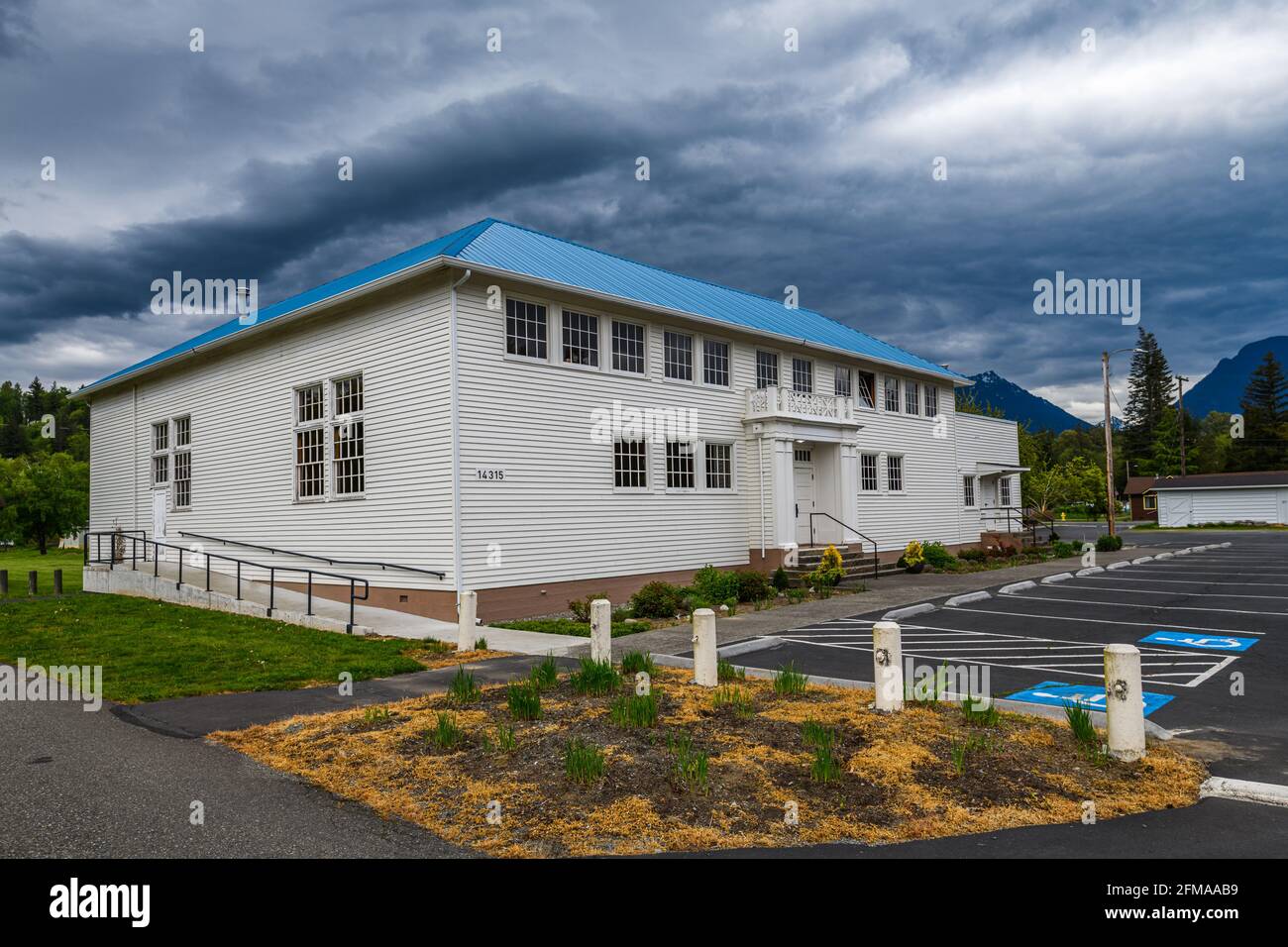 Startup, WA, USA - May 06, 2021; The Startup Event Center in the Cascade Foothills near Sultan with moody spring skies above the restored building. Stock Photo