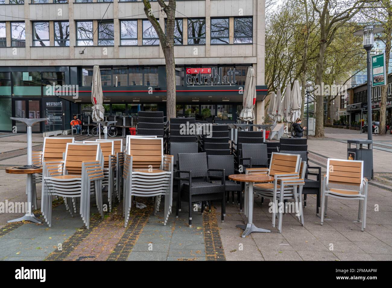 Stacked chairs and tables from various catering businesses, on