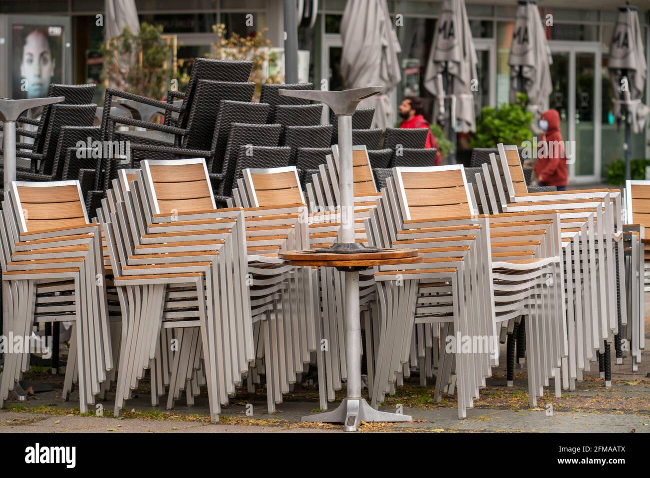 Stacked chairs and tables from various catering businesses, on