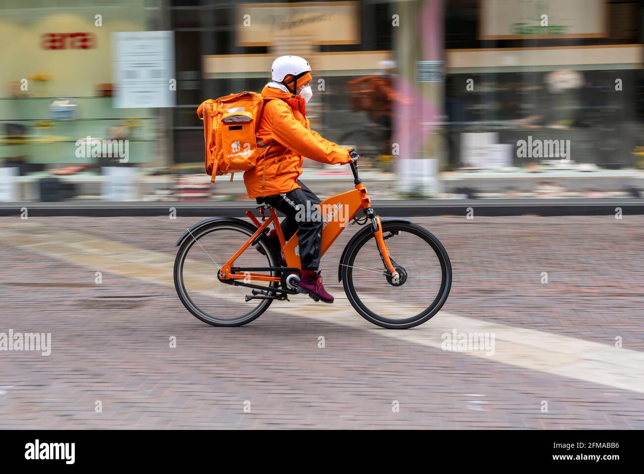 Delivery service Lieferando.de, delivery messenger with companies bicycle  in the city centre, Rathenaustrasse, in Essen, NRW Germany Stock Photo -  Alamy