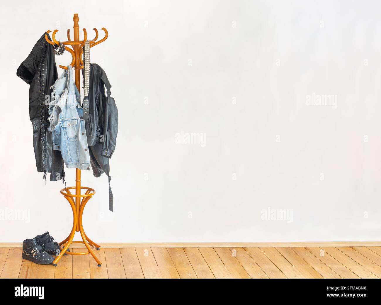 The biker leather clothes hanging on a hanger in an empty room Stock Photo