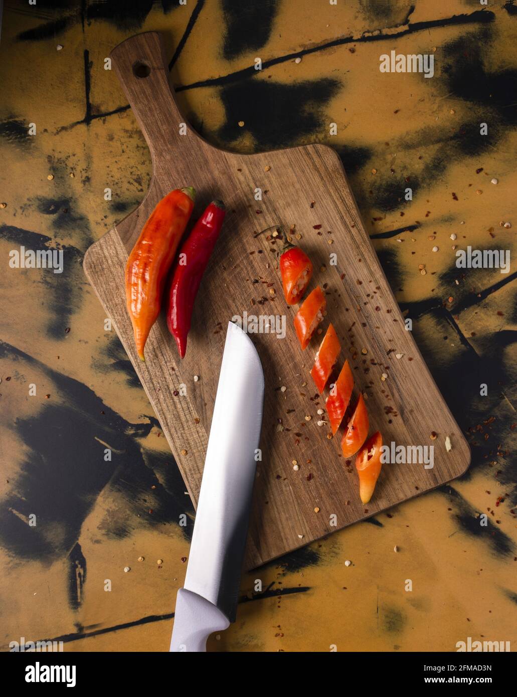 Top view of chili peppers on a chopping board Stock Photo - Alamy