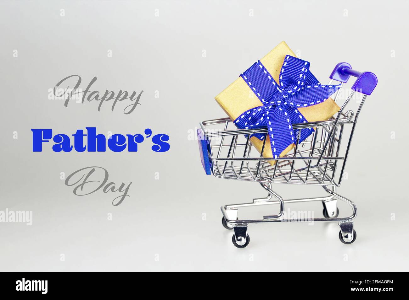 Fathers Day gift in shopping cart. Happy Fathers Day card Stock Photo