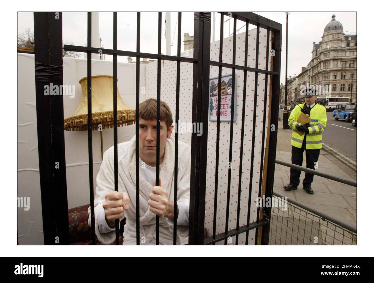 Amnesty International & Liberty demonstrate outside Parliament against the Prevention of Terrorism Bill.A home cell was set up on Parliament green as part of the demo. pic David Sandison 9/3/2004 Stock Photo