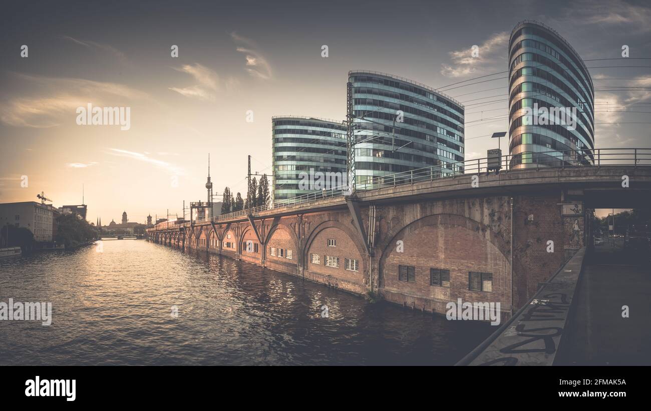 Sunset behind the Trias Towers on the Spree with the Berlin TV tower in the background. Stock Photo