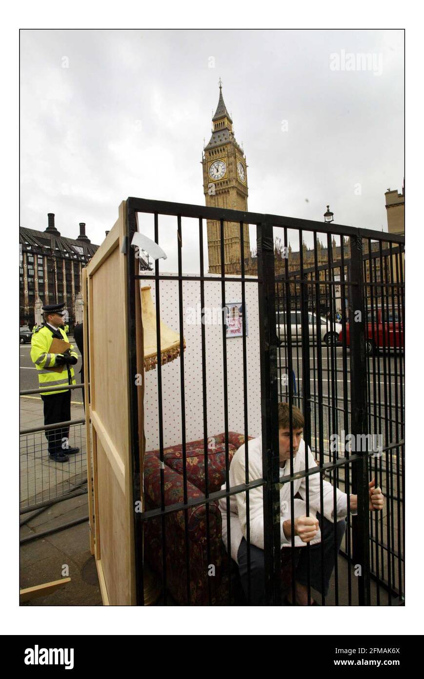 Amnesty International & Liberty demonstrate outside Parliament against the Prevention of Terrorism Bill.A home cell was set up on Parliament green as part of the demo. pic David Sandison 9/3/2004 Stock Photo
