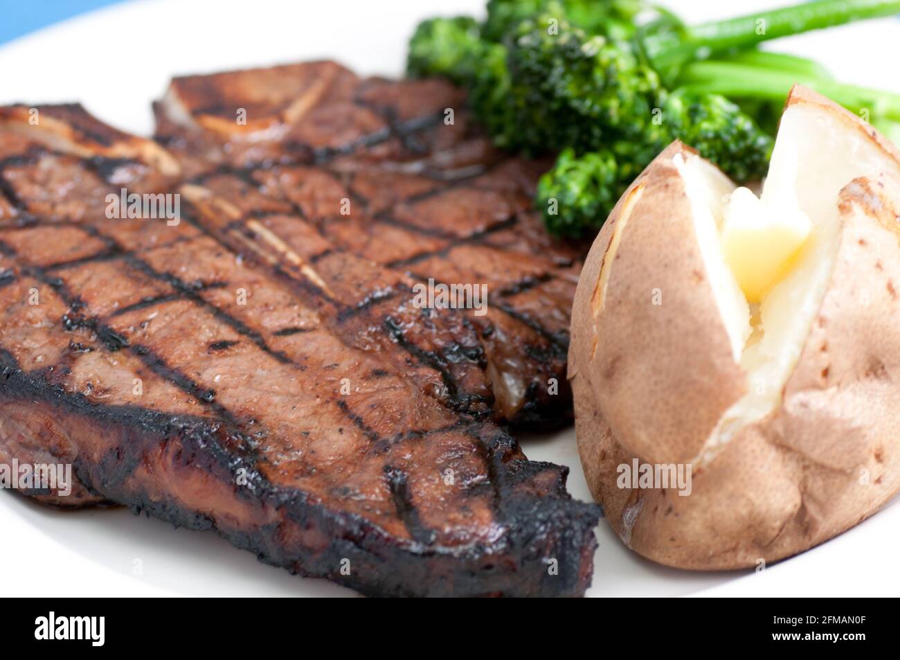 tbone steak and baked potato Stock Photo Alamy
