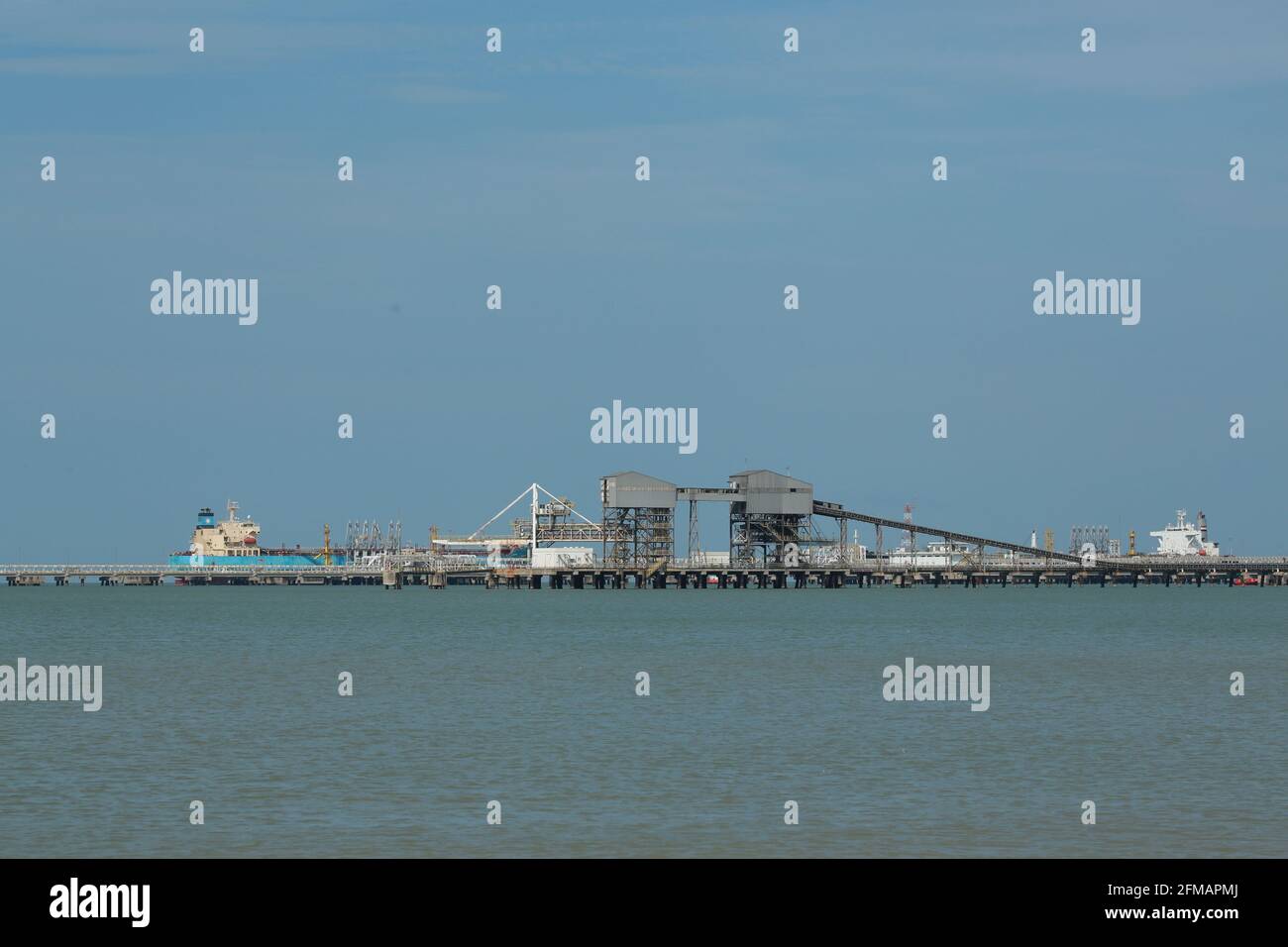 MALACCA, MALAYSIA - Jan 10, 2021: Malacca, 10 January 2021. The Scenery from beach site with oil and gas platform. Kid playing with kite and other peo Stock Photo