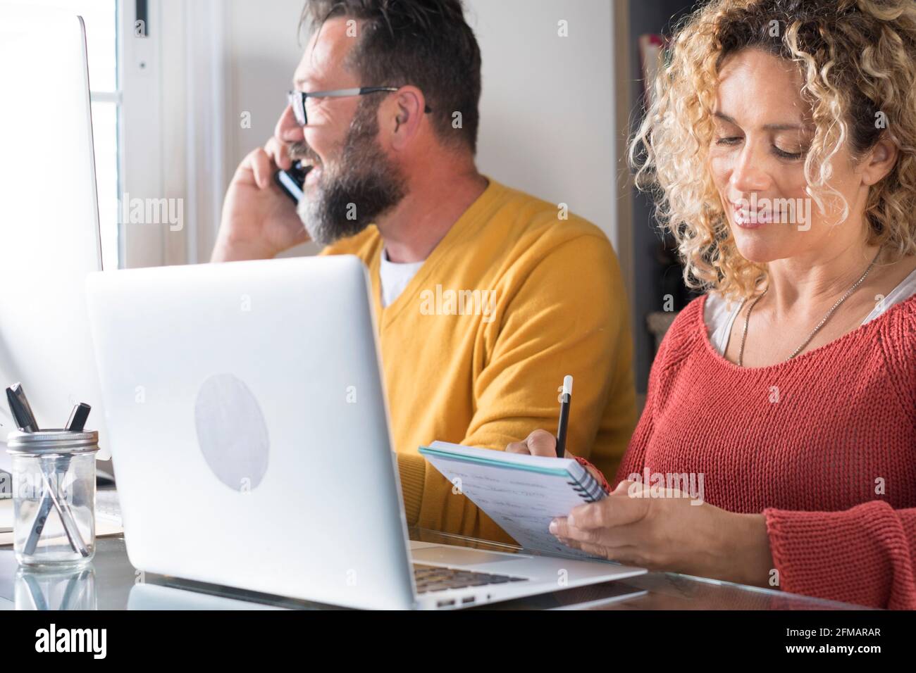 Happy man and woman couple work at home in smart working office ...