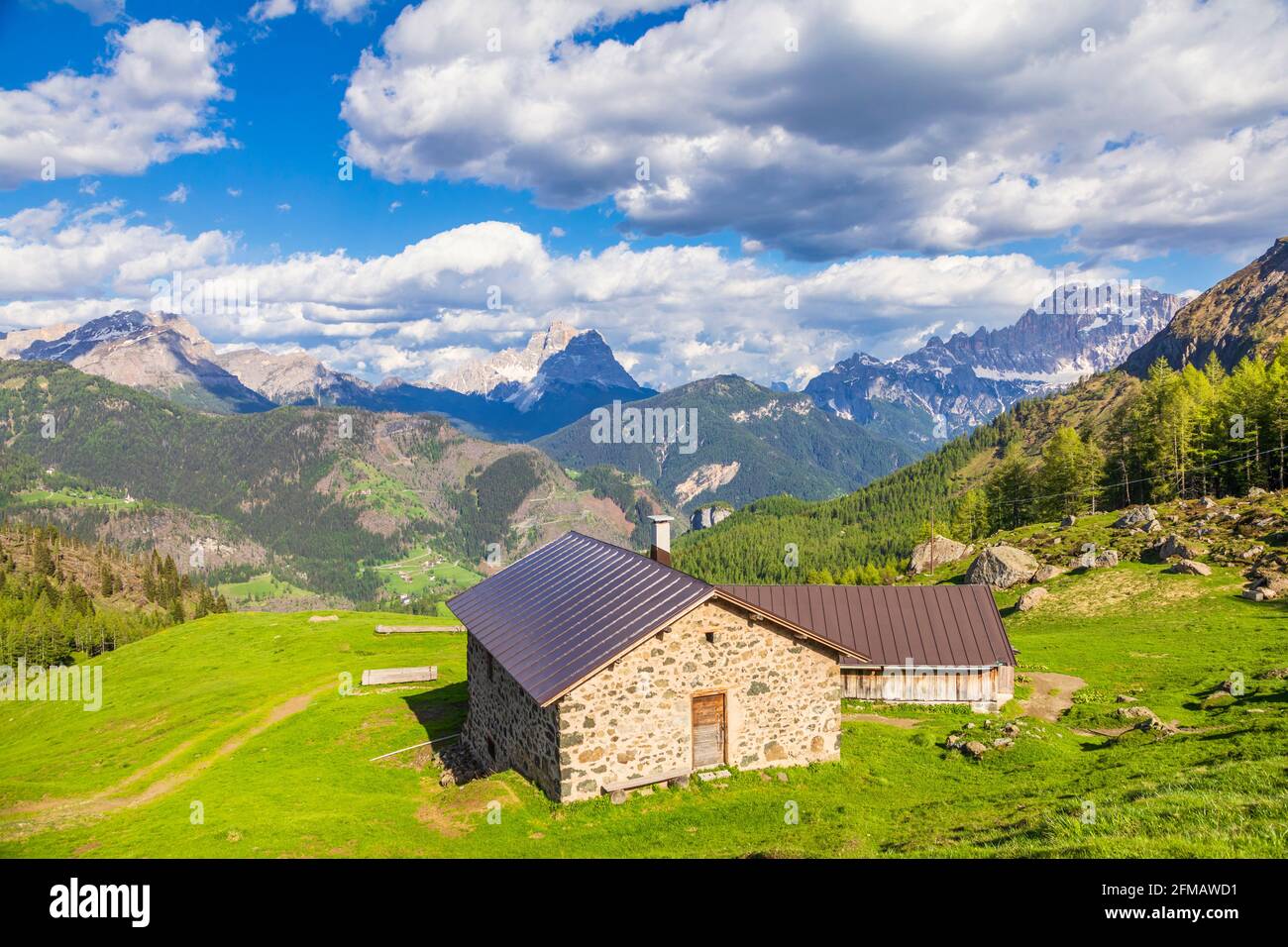 mountain huts in summer, high altitude rural scenery in the dolomites, pastures of Laste, rocca Pietore, Belluno, Veneto, Italy Stock Photo
