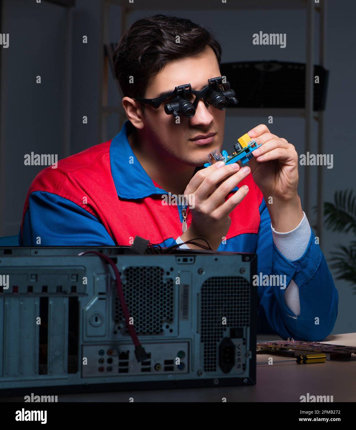 The computer specialist repairing pc late at night Stock Photo - Alamy
