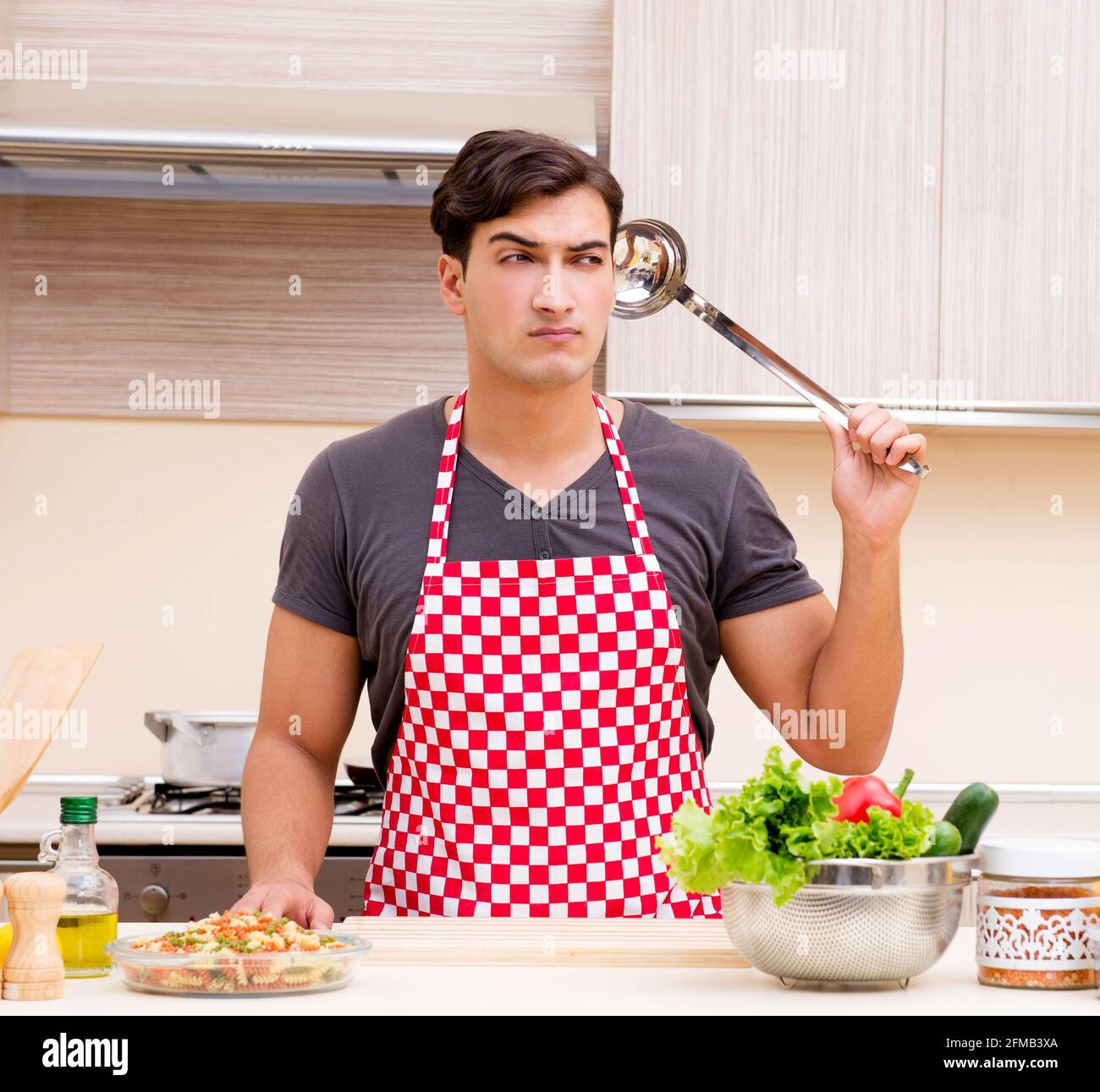 The man male cook preparing food in kitchen Stock Photo - Alamy