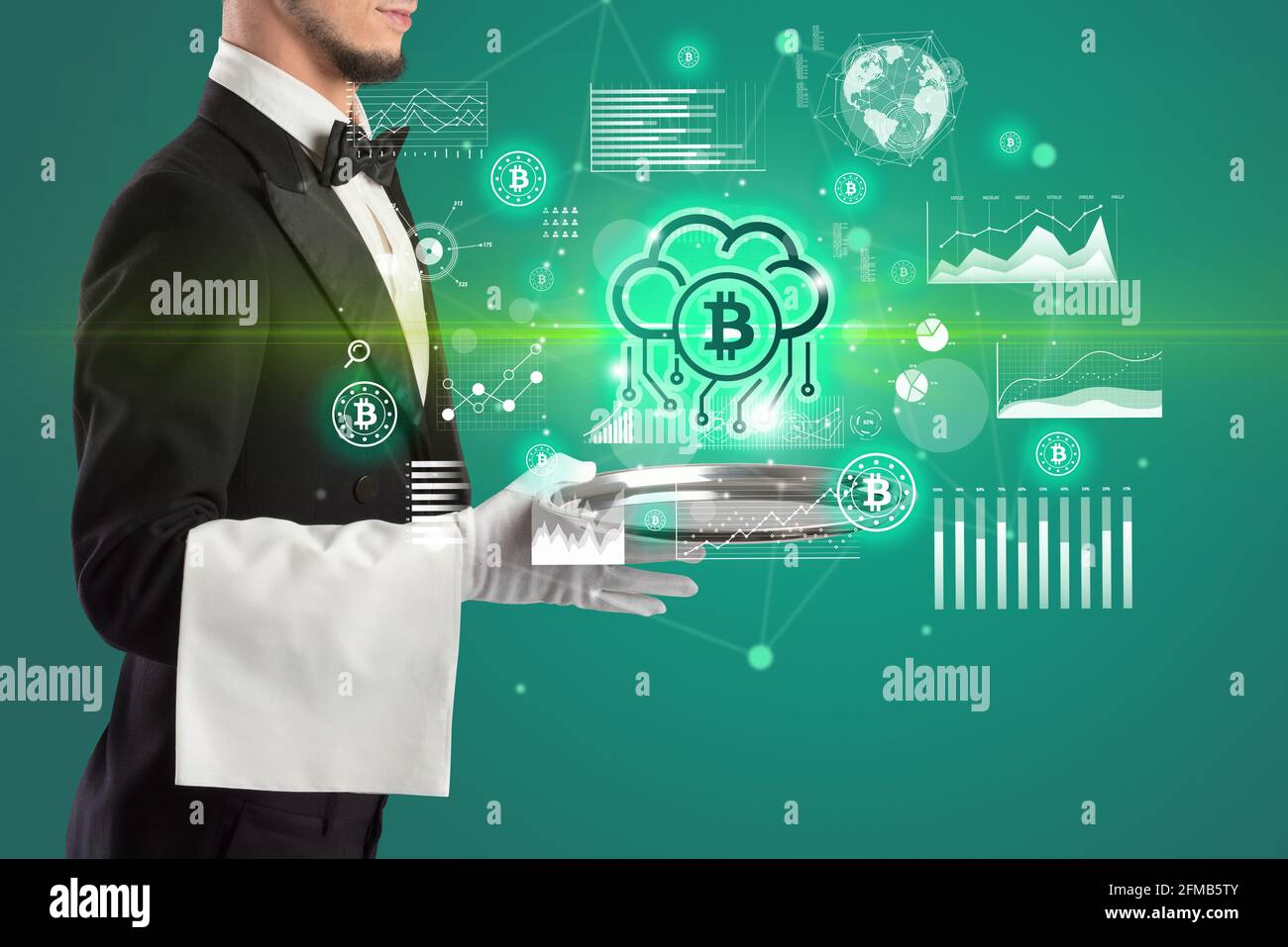 Handsome young waiter in tuxedo holding currency icons on tray Stock Photo