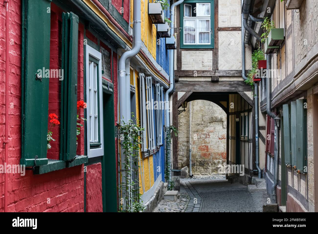 Germany, Saxony-Anhalt, Quedlinburg, narrow lane, colorful half-timbered houses in the historic old town Stock Photo