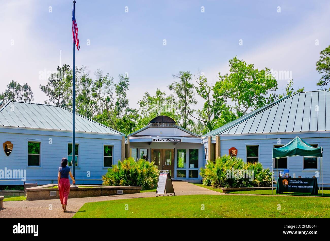 A tourist walks toward the visitor’s center at Gulf Islands National Seashore, May 1, 2021, in Ocean Springs Mississippi. Stock Photo