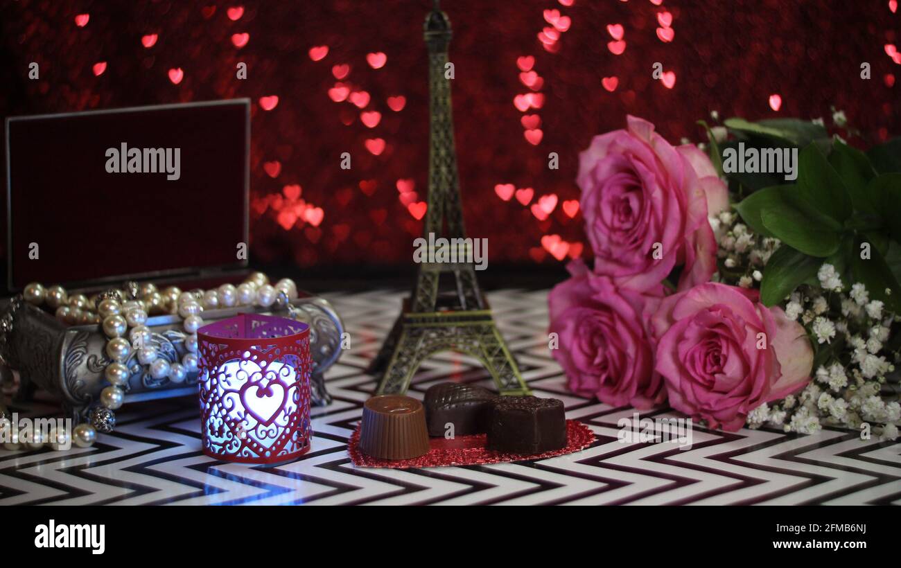Pink Rose With Eiffel Tower Replica Shallow DOF, Focus on chocolate candy Stock Photo
