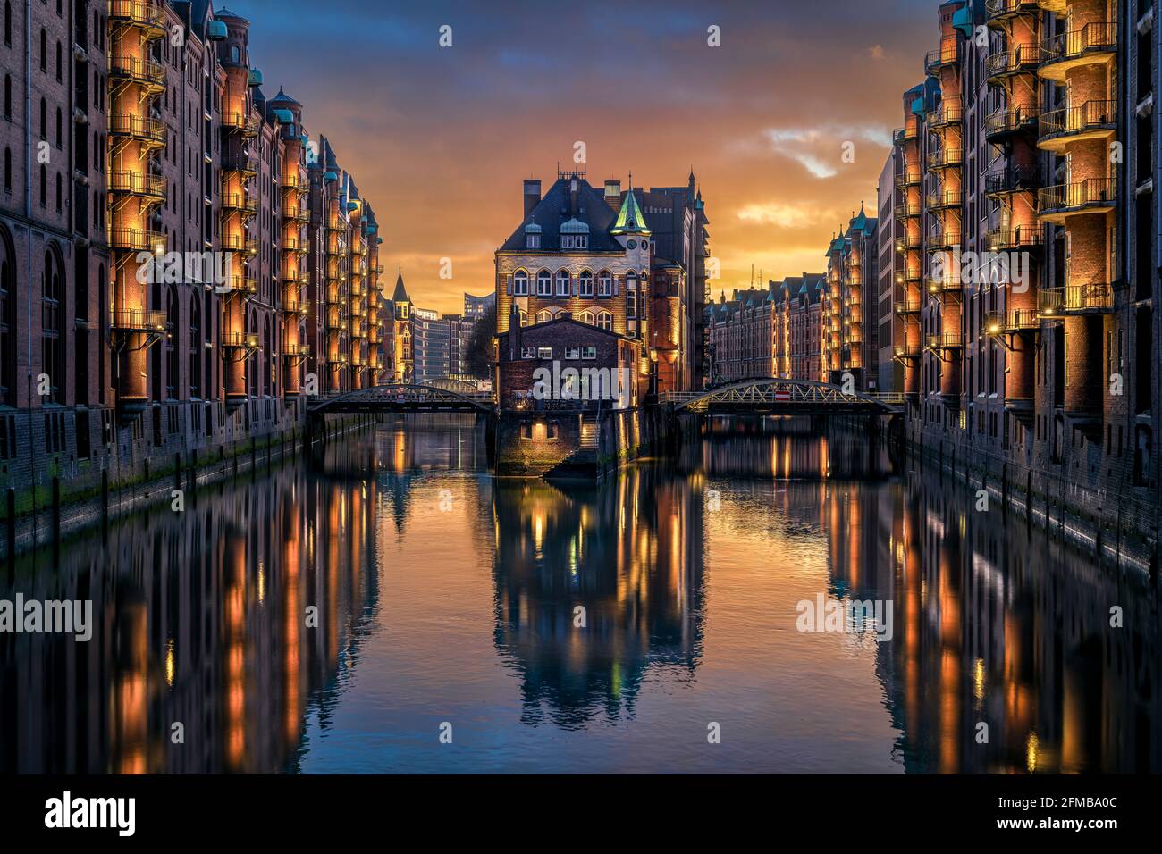 Sunset at the famous Wasserschloss (water castle) building in the historic Speicherstadt in Hamburg, Germany Stock Photo