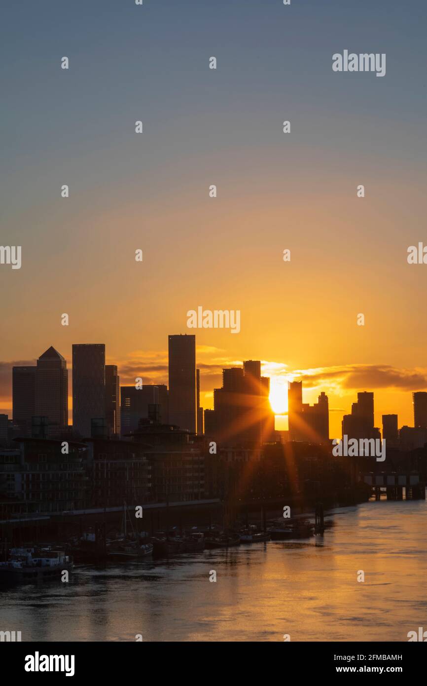 England, London, Docklands, Sunrise over River Thames and Canary Wharf Skyline Stock Photo