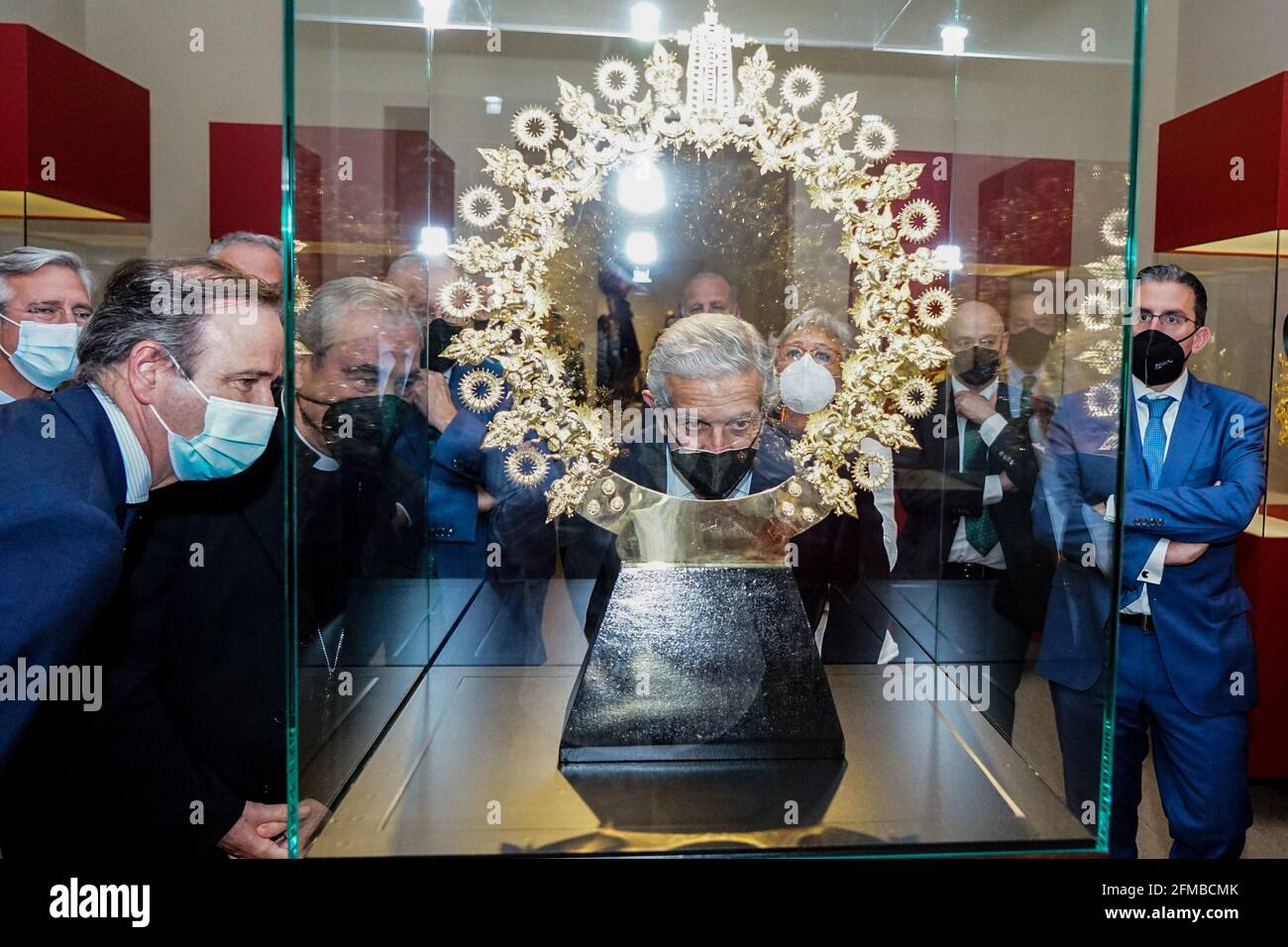 (L to R) President of Agrupacion de Cofradias de Semana Santa de Malaga, Pablo Atencia; Malaga Bishop, Jesus Catala Ibañez; and President of Fundacion Unicaja Braulio Medel observe an exposed crown property of Congregacion de Mena during the exhibition at Centro Cultural Fundacion Unicaja.'Un siglo de esplendor' is an exhibition that shows the artistic heritage of the Holy Week brotherhoods of Malaga and is one of the events organized by Agrupacion de Cofradias de Semana Santa de Malaga for the centenary of the institution. (Photo by Francis Gonzalez/SOPA Images/Sipa USA) Stock Photo