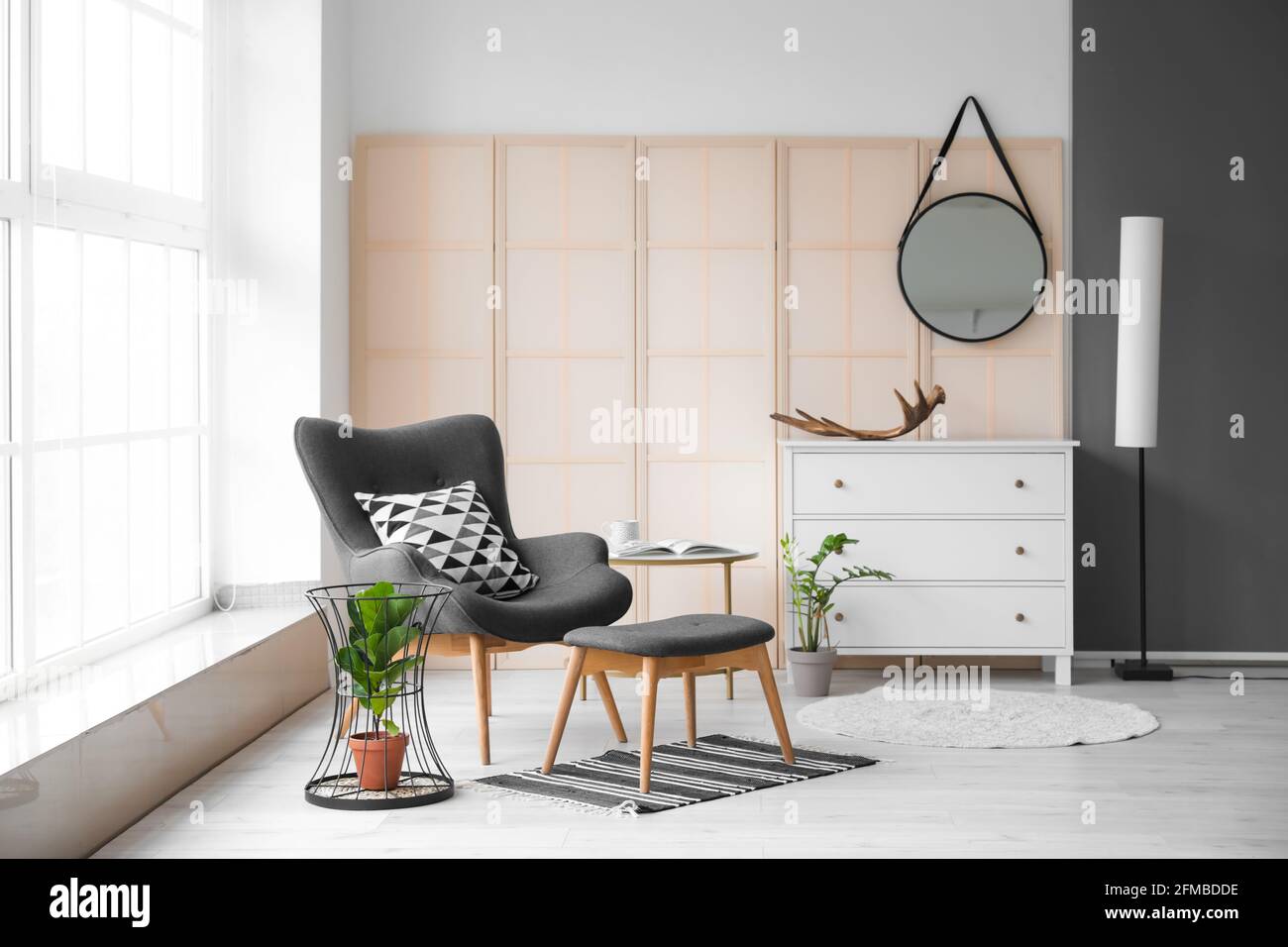 Interior of modern room with comfortable armchair and table Stock Photo ...