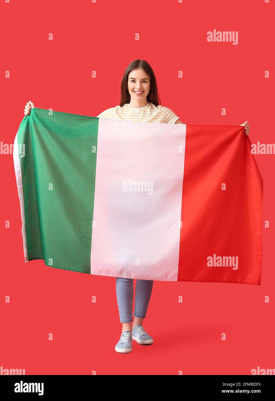 Beautiful young woman with Italian flag on color background Stock Photo