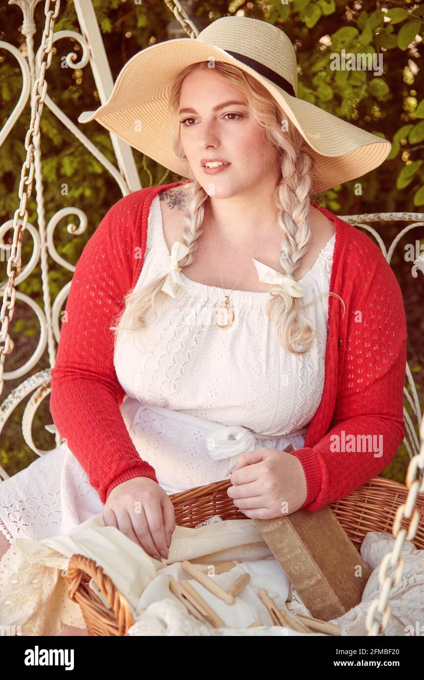 Young blonde woman with laundry basket and book Stock Photo - Alamy