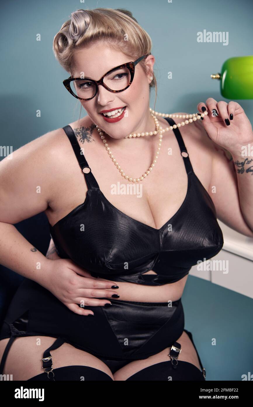 Blonde pin-up in secretary look with pearl necklace Stock Photo