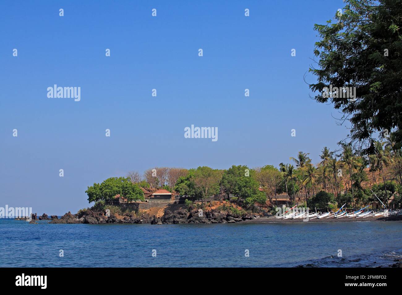 Tulamben Beach, Bali, Indonesia, is a scuba divers Mecca. Looking south east, toward the village temple and the Drop Off dive site. Stock Photo