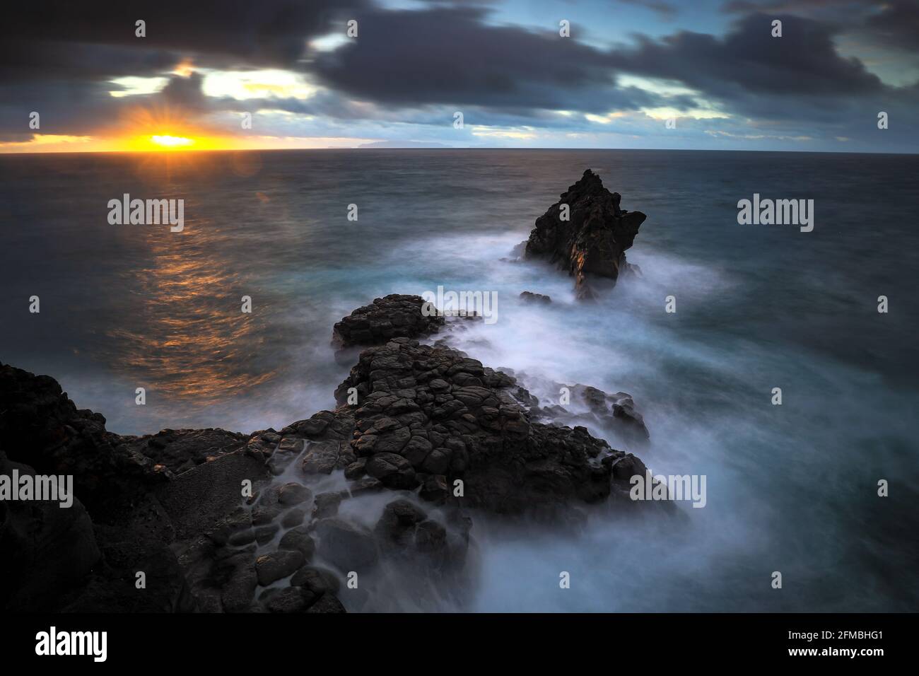 A rock needle on Madeira at sunrise near Ilheu. Stock Photo