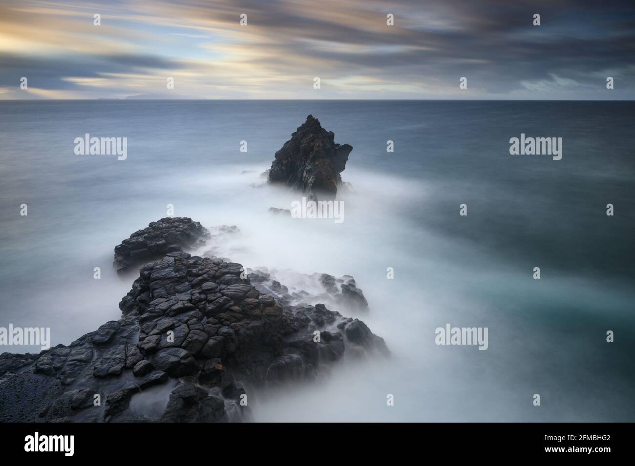 A rock needle on Madeira at sunrise near Ilheu. Stock Photo