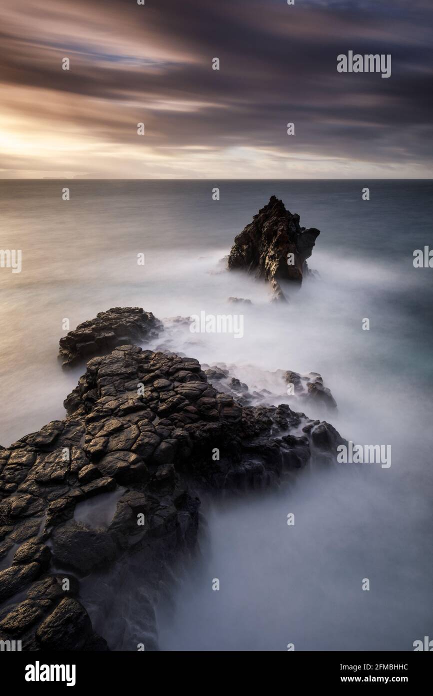 A rock needle on Madeira at sunrise near Ilheu. Stock Photo