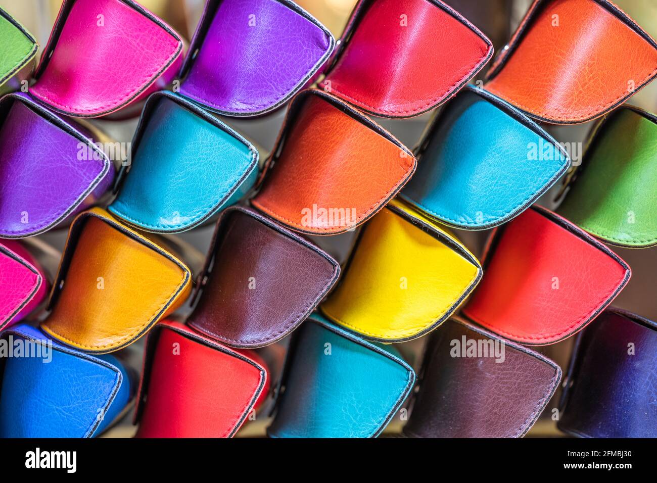 Colorful vibrant colours eyeglass cases handcrafted in the Florentine workshops, for sale in the Florence Porcellino market, Florence, Tuscany, Italy Stock Photo