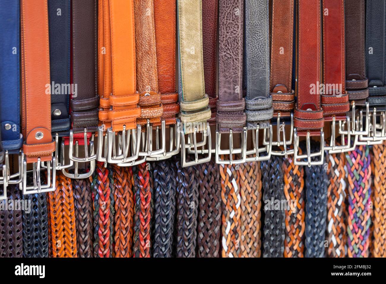 Handmade leather belts for sale on street market in Florence, Tuscany, Italy Stock Photo