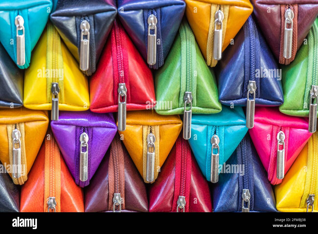 Colorful vibrant colours eyeglass cases handcrafted in the Florentine workshops, for sale in the Florence Porcellino market, Florence, Tuscany, Italy Stock Photo